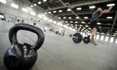 Joint Base Elmendorf-Richardson, Alaska -- Airmen, soldiers and civilians participate in a Crossfit fitness program at Hangar 5 on Joint Base Elmendorf-Richardson after duty hours, Wednesday, July 13, 2011.  (U.S. Air Force/Justin Connaher)